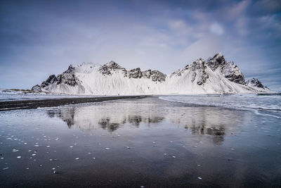 Scenic view of frozen lake against sky during winter