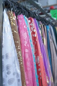 Close-up of clothes hanging in store