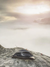 Car on land by sea against sky