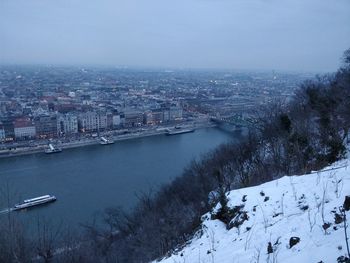 High angle view of river and cityscape during winter