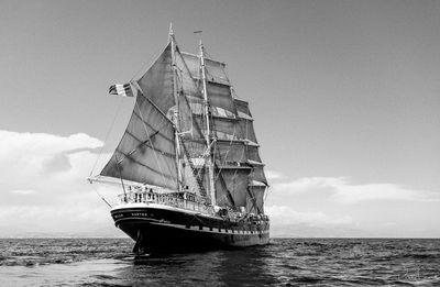 Ship sailing on sea against sky