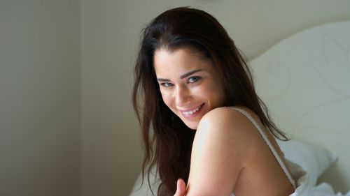 Portrait of smiling woman sitting at home