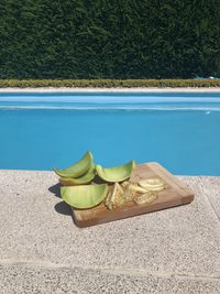 High angle view of shoes by swimming pool against lake