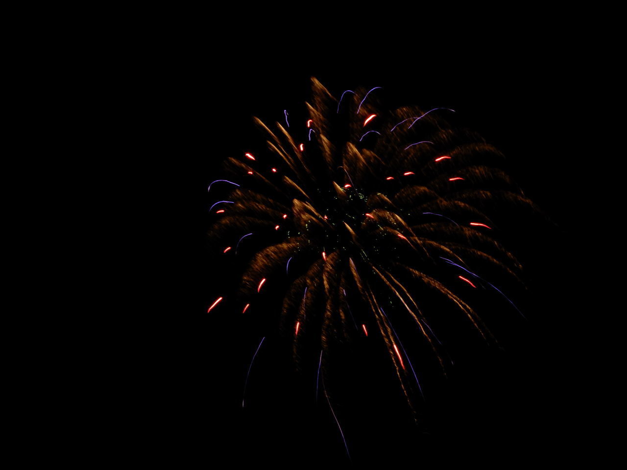 LOW ANGLE VIEW OF FIREWORKS IN SKY