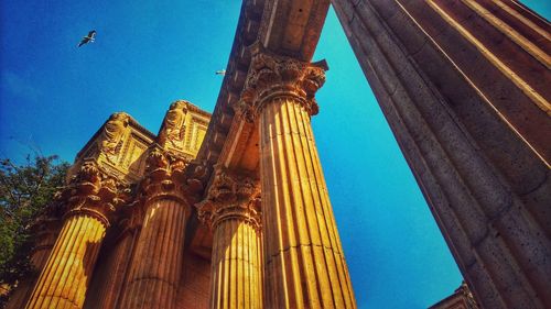 Low angle view of temple building against blue sky