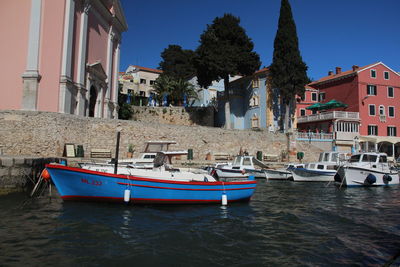 Boats moored in sea against sky