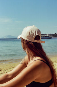 Portrait of woman wearing hat at beach