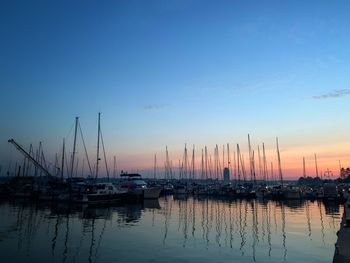 Sailboats in marina at sunset