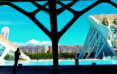 Bridge over river against buildings in city
