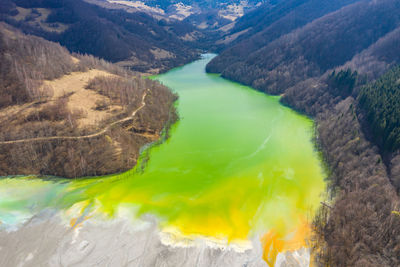 Aerial drone view of toxic chemical residuals flooding a lake from a copper mine