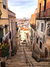 Street amidst buildings in town against sky