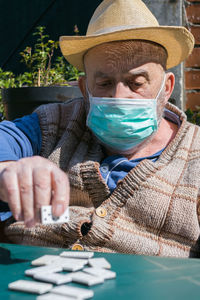 Portrait of man holding hat