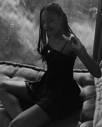 Portrait of young woman sitting outdoors