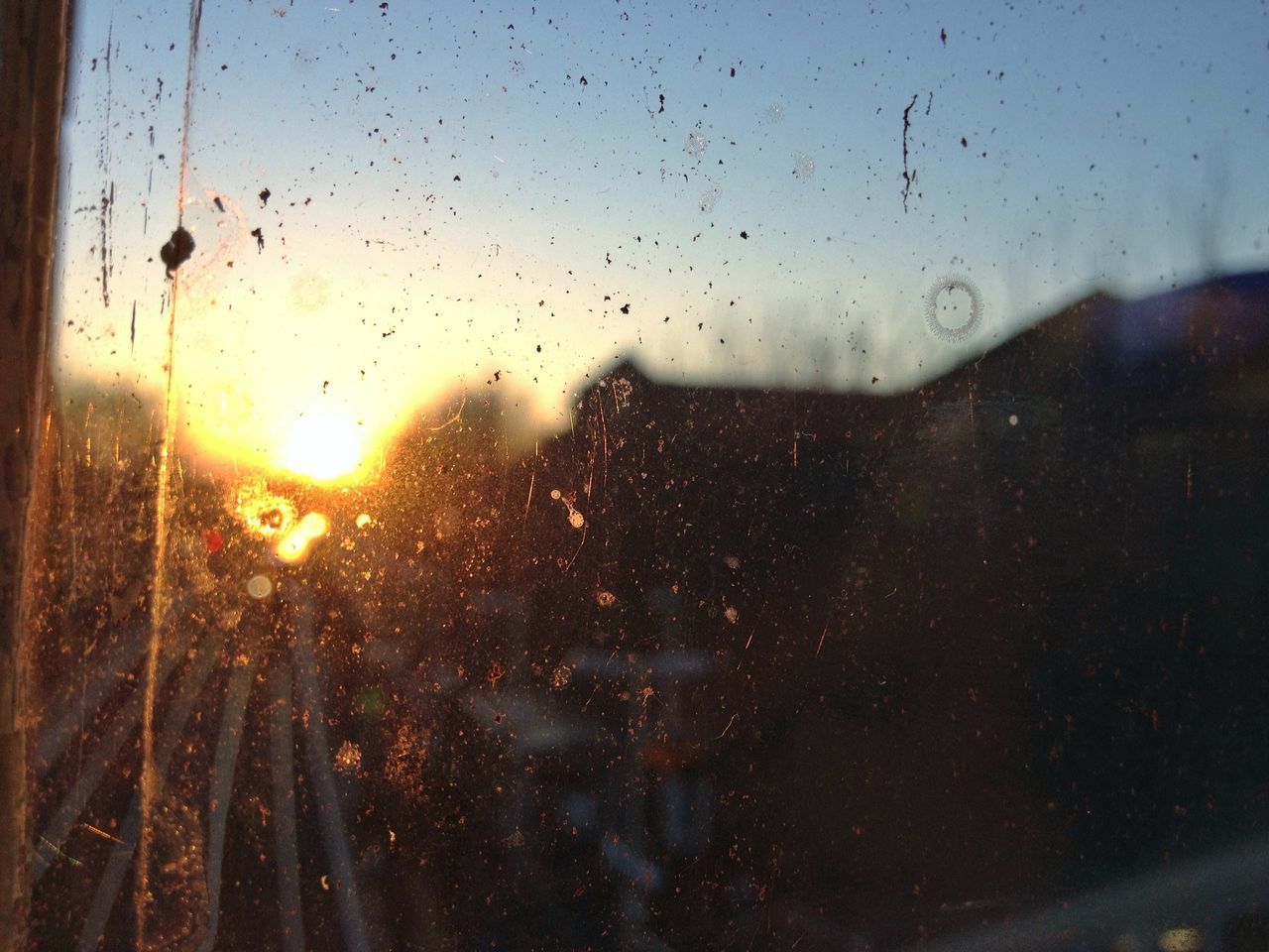 sunset, window, drop, transparent, sky, wet, nature, water, glass - material, silhouette, sun, beauty in nature, flying, animal themes, weather, no people, indoors, tranquility, dusk, focus on foreground