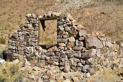 Ruins of stone house in ghost town in nevada desert landscape