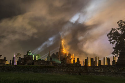 Panoramic view of buildings against cloudy sky