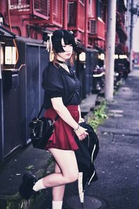 Woman with umbrella in city