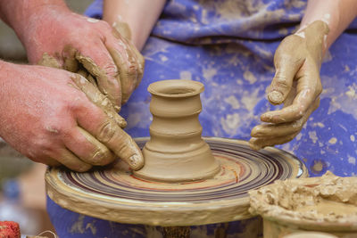 Close-up of people making pottery