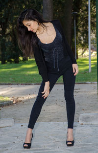 Full length of woman on footpath