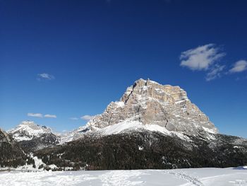 Scenic view of snowcapped mountains against blue sky