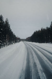 Snow covered landscape against clear sky