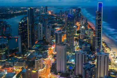 High angle view of city lit up at night