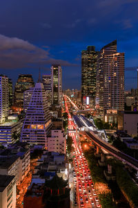 High angle view of illuminated street amidst buildings in city