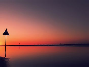 Scenic view of sea against romantic sky at sunset