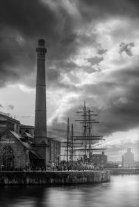 Low angle view of tower against cloudy sky