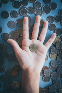Cropped image of hand holding coin