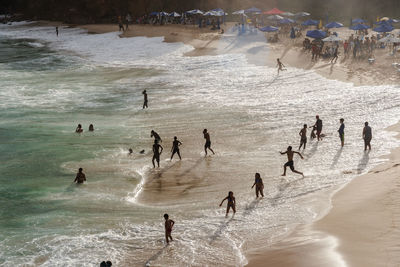 Large group of people on paciencia beach in the rio vermelho neighborhood of salvador, brazil.