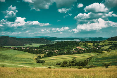 Scenic view of agricultural field against sky