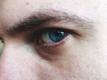 Cropped portrait of man with blue eyes