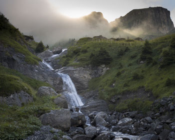 Scenic view of waterfall against sky