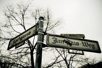 Low angle view of road sign against sky