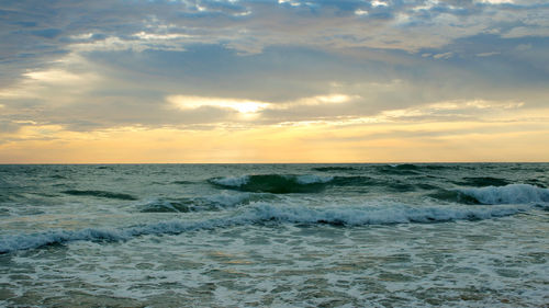 Beautiful sunset on the beach. the surf pounds the shore. phuket, thailand