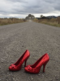 Close-up of shoes on sand