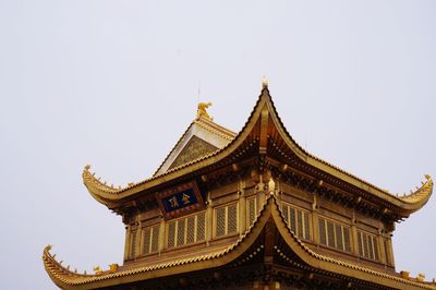 Low angle view of golden summit temple against sky