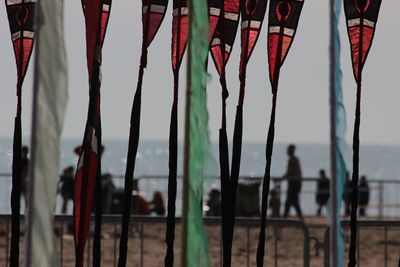 Clothes hanging by sea against sky