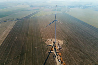 Construction site near windmill turbine, wind generator installing