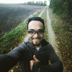 Portrait of smiling young man in field