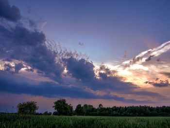 Scenic view of field against cloudy sky