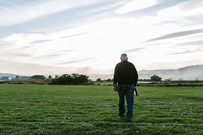 Spain, tarragona, senior man walking in the field