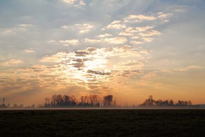 Scenic view of field against sky during sunset