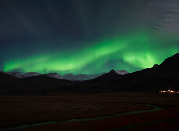 Scenic view of illuminated mountains against sky at night