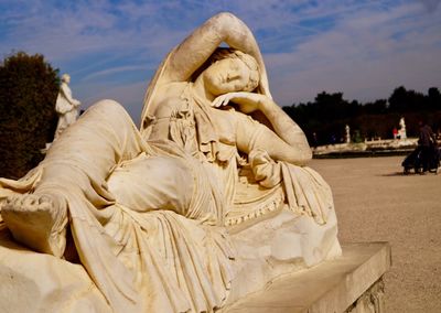 Close-up of statue at beach against sky