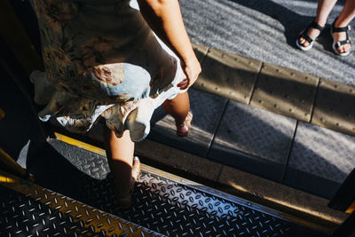 Low section of women walking on footpath