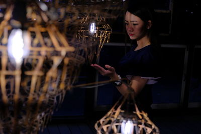 Woman buying illuminated lantern in store