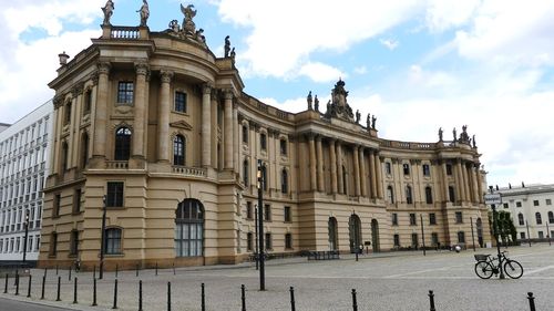 Low angle view of building against cloudy sky