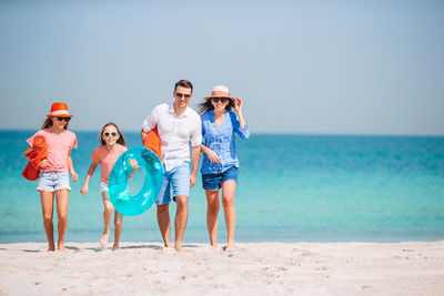 People on beach against clear sky